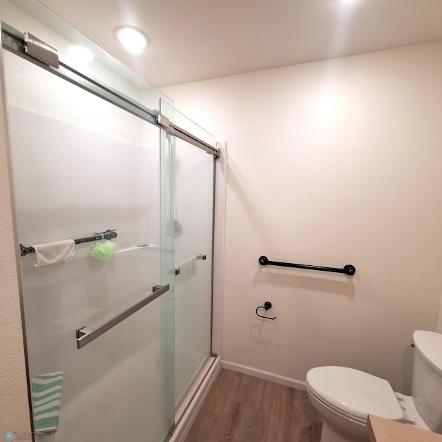 409 Prairieview St, St Thomas, ND 58276 - bathroom featuring toilet, a stall shower, wood finished floors, and baseboards