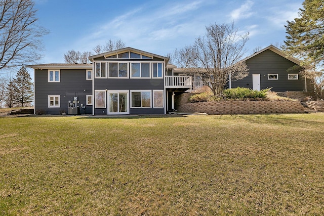 rear view of property with a deck, a yard, and central AC unit