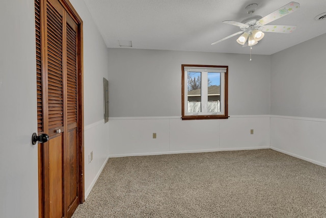 unfurnished bedroom featuring visible vents, a ceiling fan, a closet, and carpet flooring