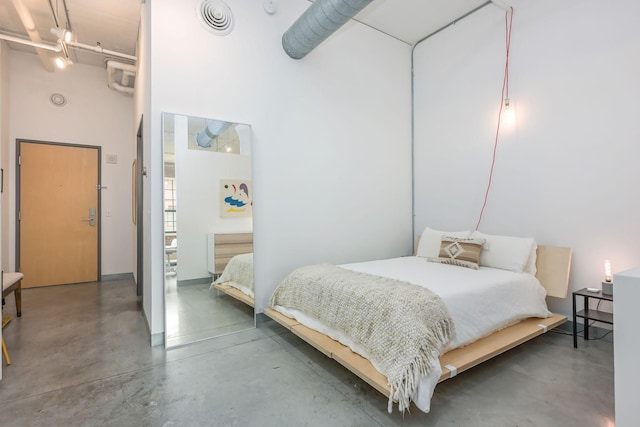 250 Park Ave Unit 601, Minneapolis, MN 55415 - bedroom with concrete floors and a towering ceiling