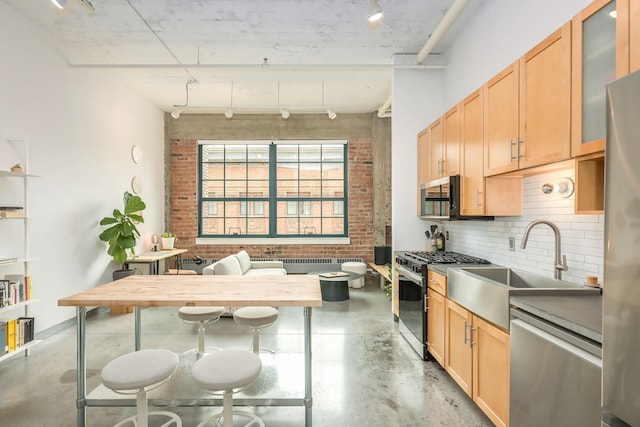 250 Park Ave Unit 601, Minneapolis, MN 55415 - kitchen with appliances with stainless steel finishes, concrete flooring, tasteful backsplash, glass insert cabinets, and light brown cabinetry