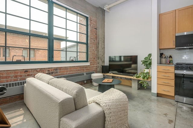 250 Park Ave Unit 601, Minneapolis, MN 55415 - living area with radiator, concrete flooring, and brick wall