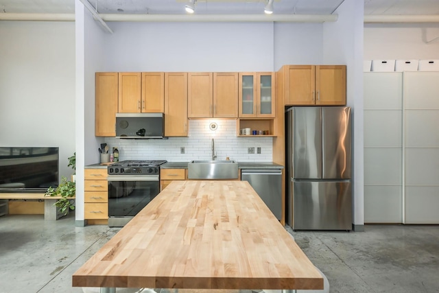 250 Park Ave Unit 601, Minneapolis, MN 55415 - kitchen featuring stainless steel appliances, wooden counters, concrete floors, and backsplash