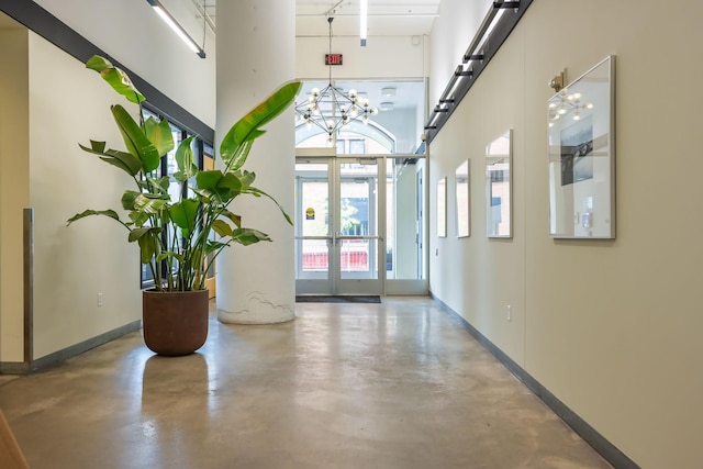 250 Park Ave Unit 601, Minneapolis, MN 55415 - entryway with concrete floors, a towering ceiling, french doors, and a chandelier