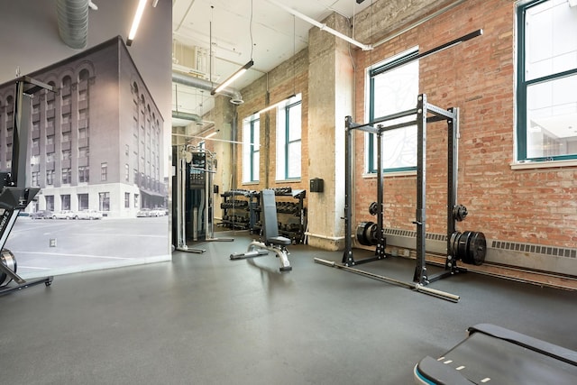 250 Park Ave Unit 601, Minneapolis, MN 55415 - workout area featuring a high ceiling and brick wall