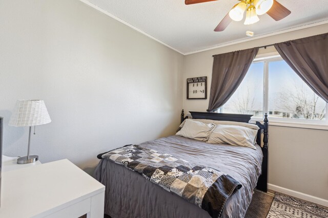 bedroom with crown molding, a ceiling fan, and baseboards