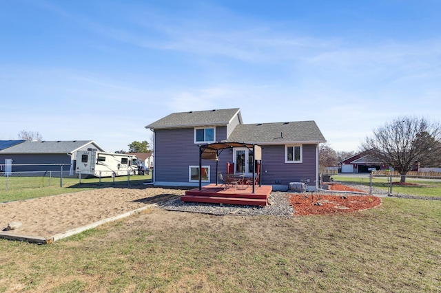 back of property featuring fence, a wooden deck, a yard, and a pergola