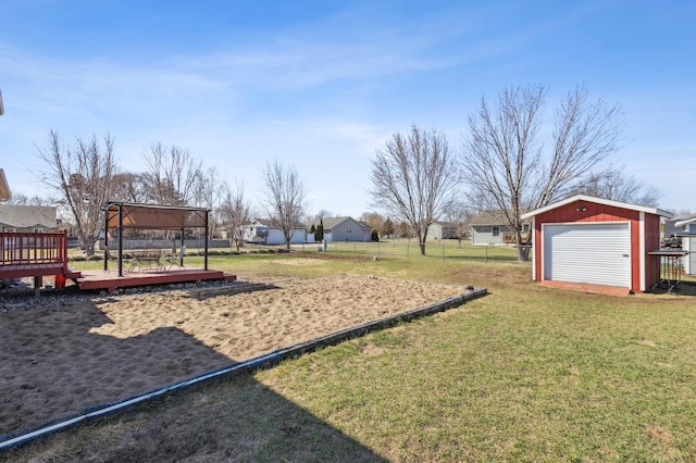 view of yard with fence, a wooden deck, a gazebo, and an outbuilding