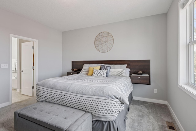 carpeted bedroom featuring baseboards and visible vents