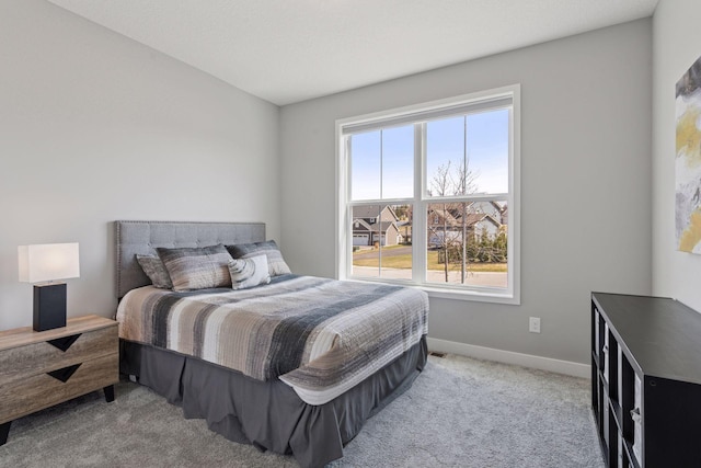 bedroom featuring carpet floors and baseboards