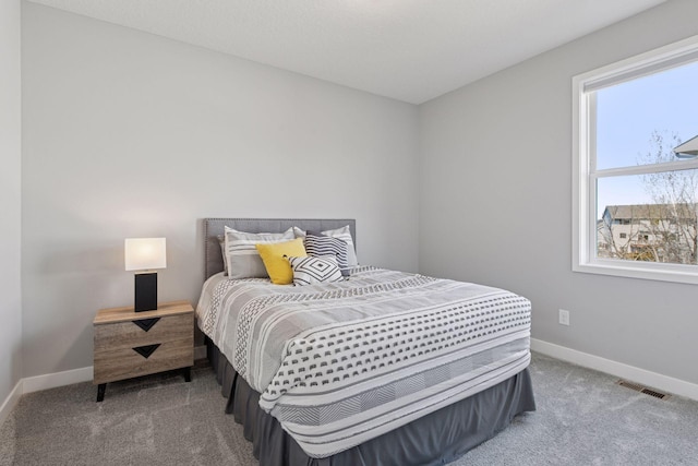 carpeted bedroom featuring visible vents and baseboards