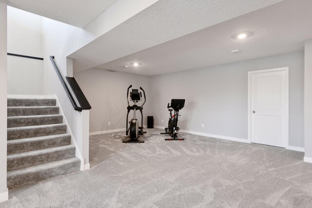 exercise area with recessed lighting, carpet floors, and baseboards