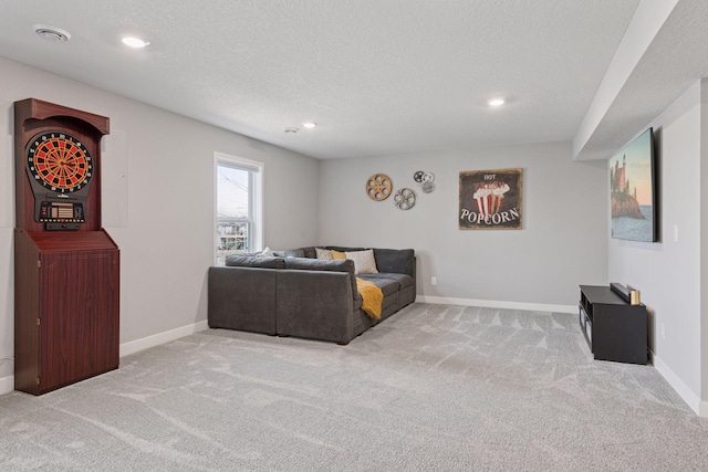carpeted living room with baseboards, a textured ceiling, and recessed lighting