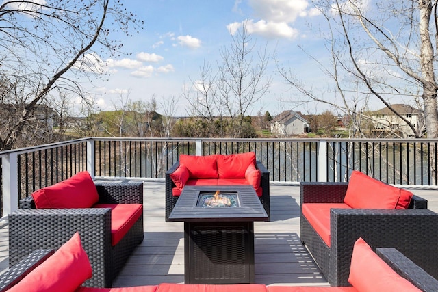 wooden terrace with an outdoor living space with a fire pit