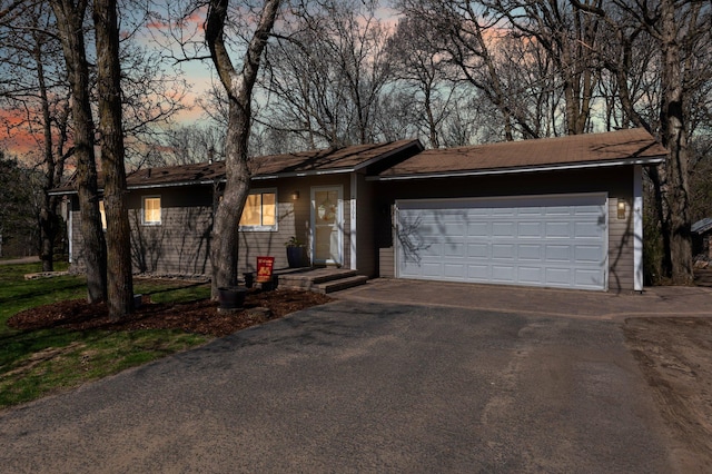 single story home with a garage and driveway