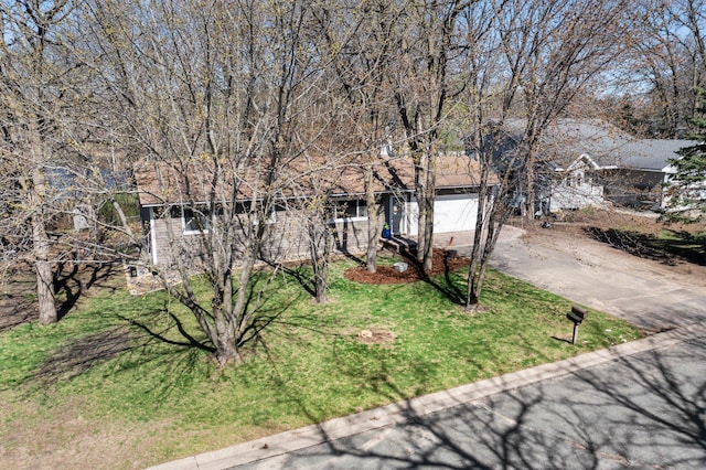 obstructed view of property featuring a garage and concrete driveway