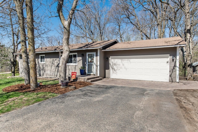 ranch-style house with an attached garage and driveway