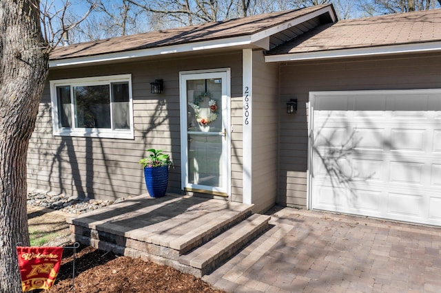 view of exterior entry with a garage