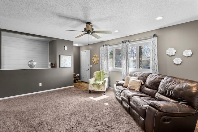 carpeted living area featuring baseboards, recessed lighting, a textured ceiling, and ceiling fan