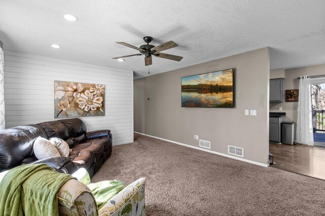 living room featuring carpet floors, a ceiling fan, baseboards, recessed lighting, and visible vents