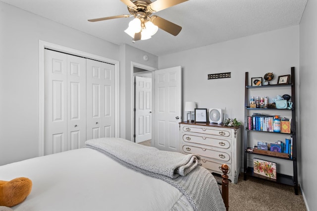carpeted bedroom with ceiling fan and a closet