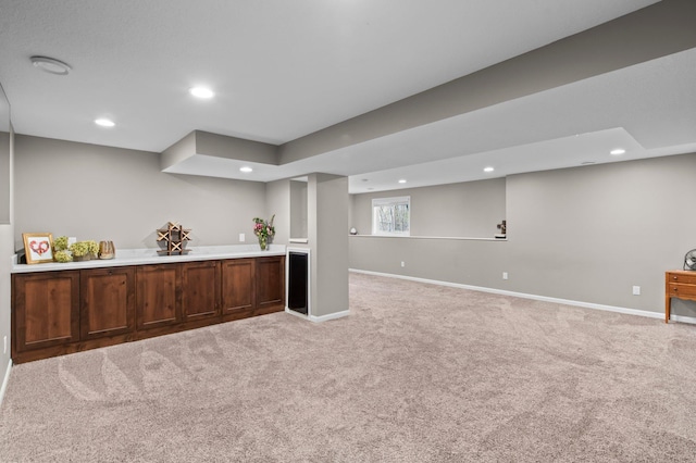bar featuring recessed lighting, baseboards, wet bar, and light carpet