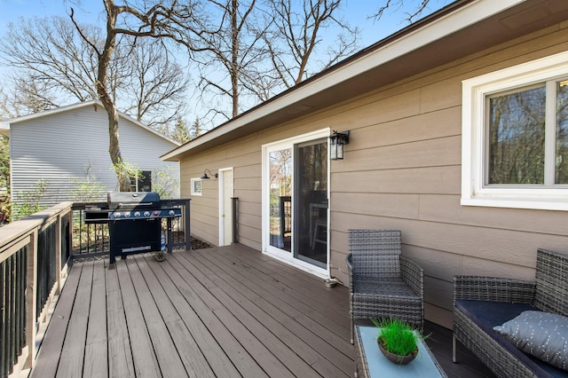 wooden terrace featuring a grill