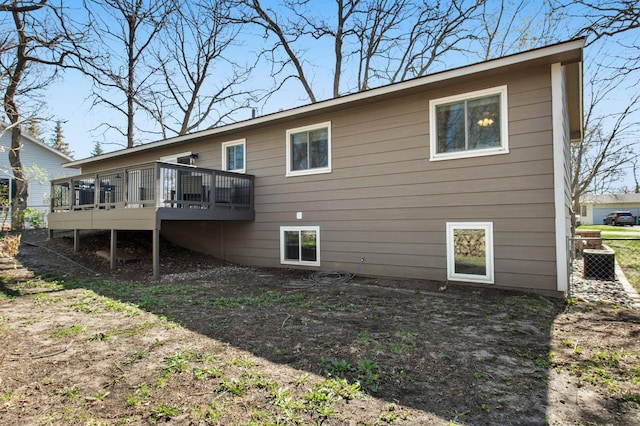 back of house with a deck