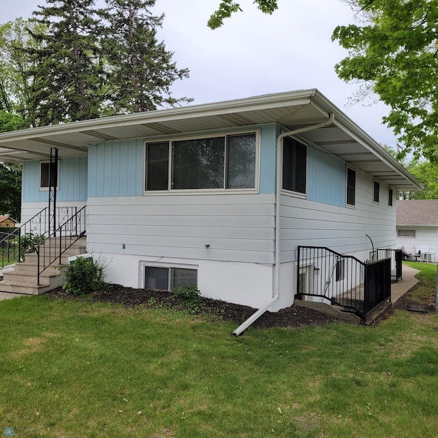 view of side of property with a yard