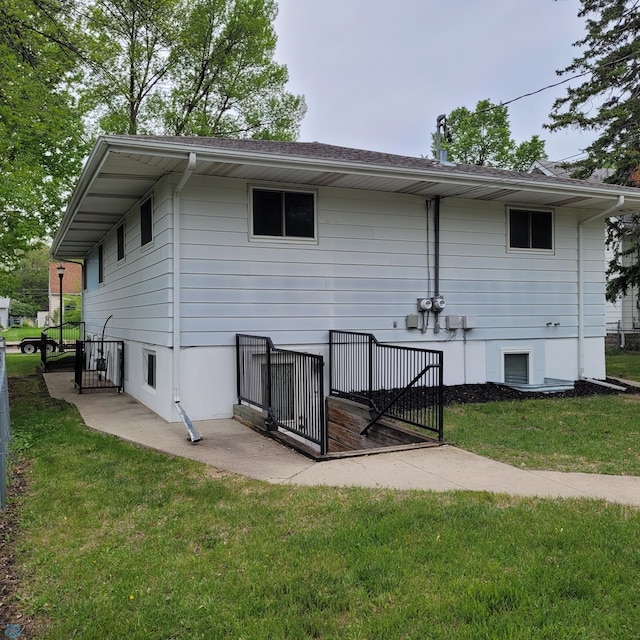 rear view of property with a yard
