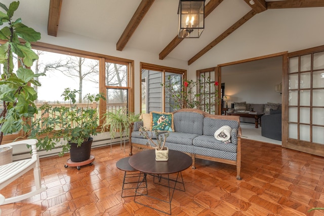 sunroom / solarium with a notable chandelier and beam ceiling