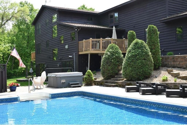 pool with a patio area, a hot tub, and an outdoor living space