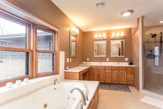 full bath with tile patterned floors, double vanity, a jetted tub, a sink, and a stall shower