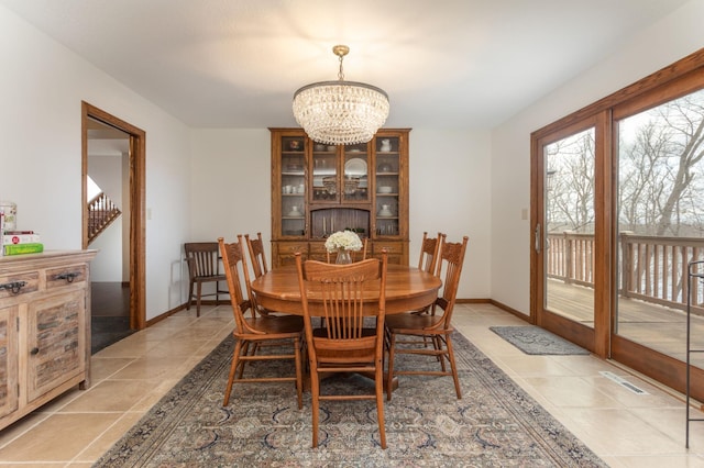 dining space featuring visible vents, baseboards, a chandelier, and light tile patterned floors