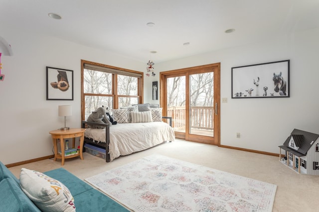 carpeted bedroom with baseboards and access to exterior