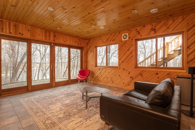 living area featuring wooden walls and wood ceiling