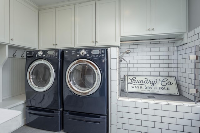 laundry room with cabinet space and washing machine and clothes dryer