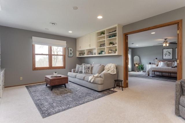 living room featuring recessed lighting, light colored carpet, and ceiling fan