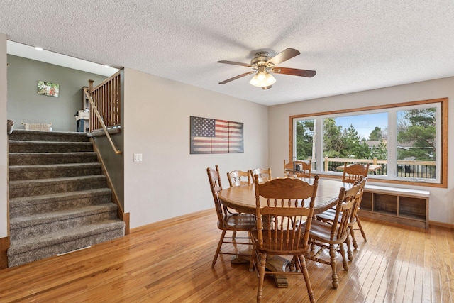 14921 Zeolite St NW, Ramsey, MN 55303 - dining area with a ceiling fan, hardwood / wood-style floors, a textured ceiling, and stairway