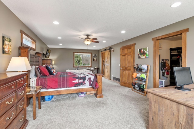 14921 Zeolite St NW, Ramsey, MN 55303 - bedroom featuring light colored carpet, a barn door, visible vents, recessed lighting, and ceiling fan