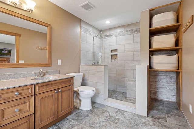 14921 Zeolite St NW, Ramsey, MN 55303 - bathroom featuring toilet, visible vents, vanity, and a walk in shower