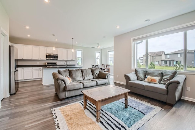 living room with light wood-style flooring, baseboards, recessed lighting, and ceiling fan