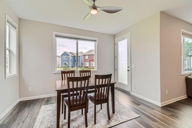 dining room featuring wood finished floors, a ceiling fan, and baseboards