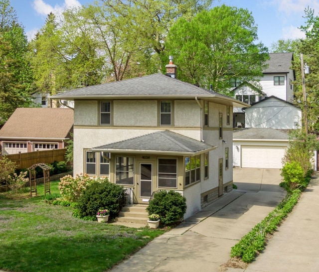 4034 Abbott Ave S, Minneapolis, MN 55410 - view of front of house featuring stucco siding, a garage, an outbuilding, concrete driveway, and a chimney