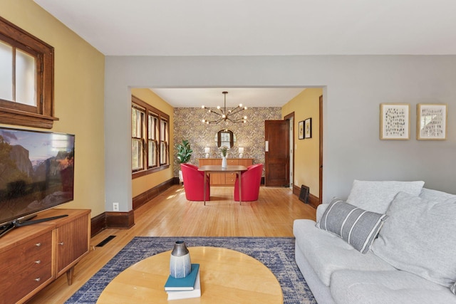4034 Abbott Ave S, Minneapolis, MN 55410 - living area with light wood-style floors, a chandelier, and baseboards