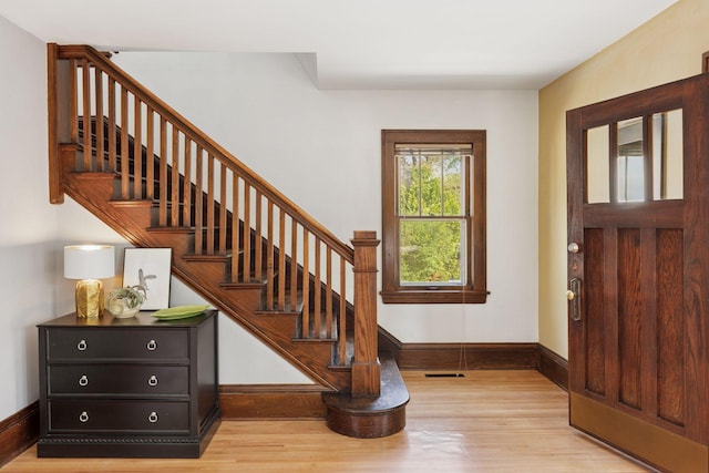 4034 Abbott Ave S, Minneapolis, MN 55410 - entrance foyer with light wood-type flooring, stairs, and baseboards