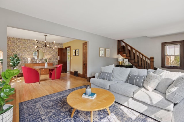 4034 Abbott Ave S, Minneapolis, MN 55410 - living area with wood finished floors, an accent wall, stairway, and a chandelier