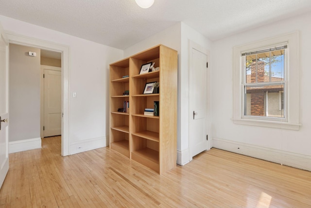 4034 Abbott Ave S, Minneapolis, MN 55410 - unfurnished bedroom with light wood-type flooring, baseboards, and a textured ceiling