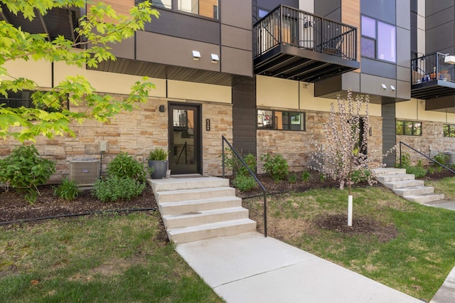 6369 16th Ave S, Richfield, MN 55423 - view of exterior entry featuring stone siding and a balcony