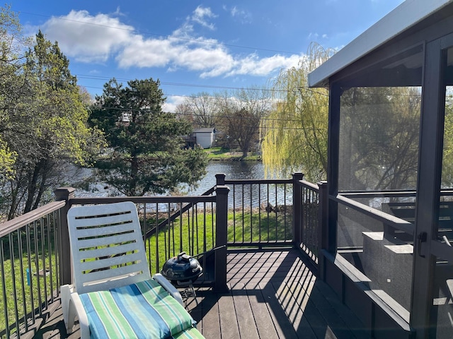 wooden deck featuring a water view